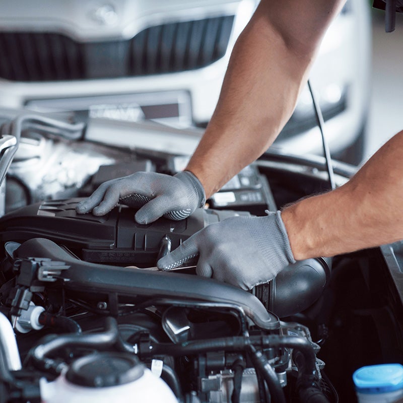 service technician looking under the hood of a car at Fitzgerald Chevrolet of Hagerstown in Hagerstown MD 